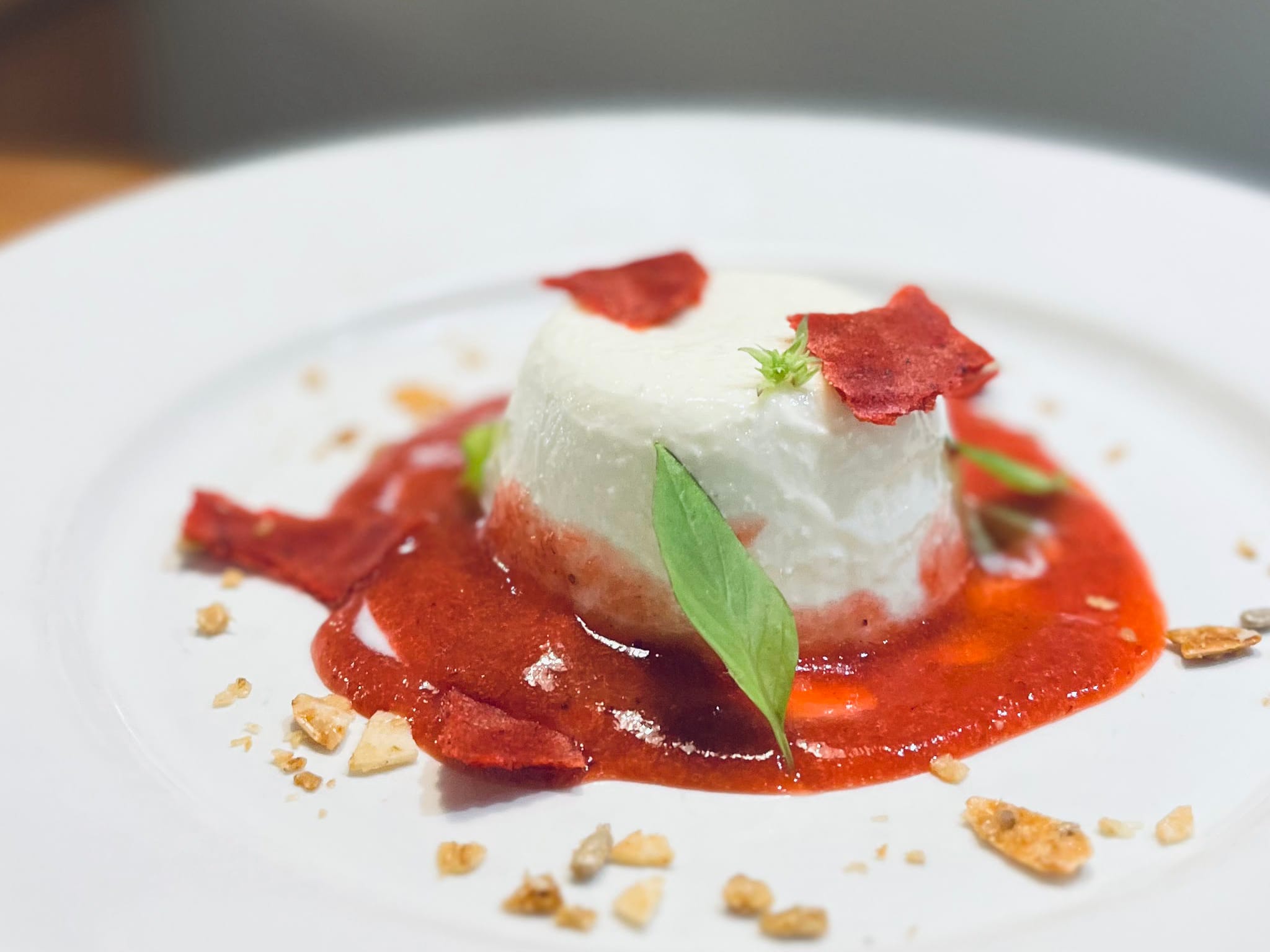 Panna cotta with strawberries and thai basil.