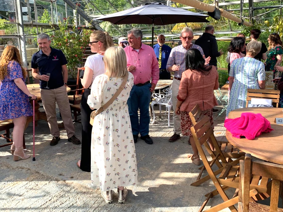 Members of the Chamber of Commerce in the greenhouse.