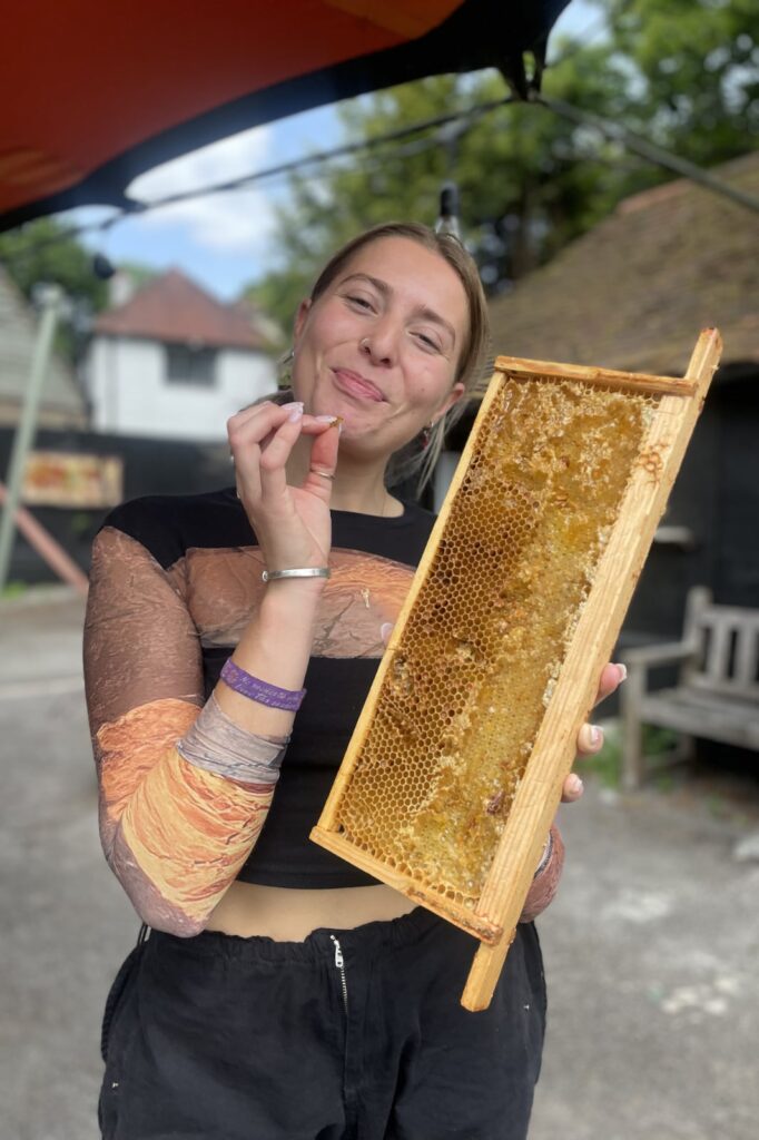 Grace trying some of the honey fresh from the hive!