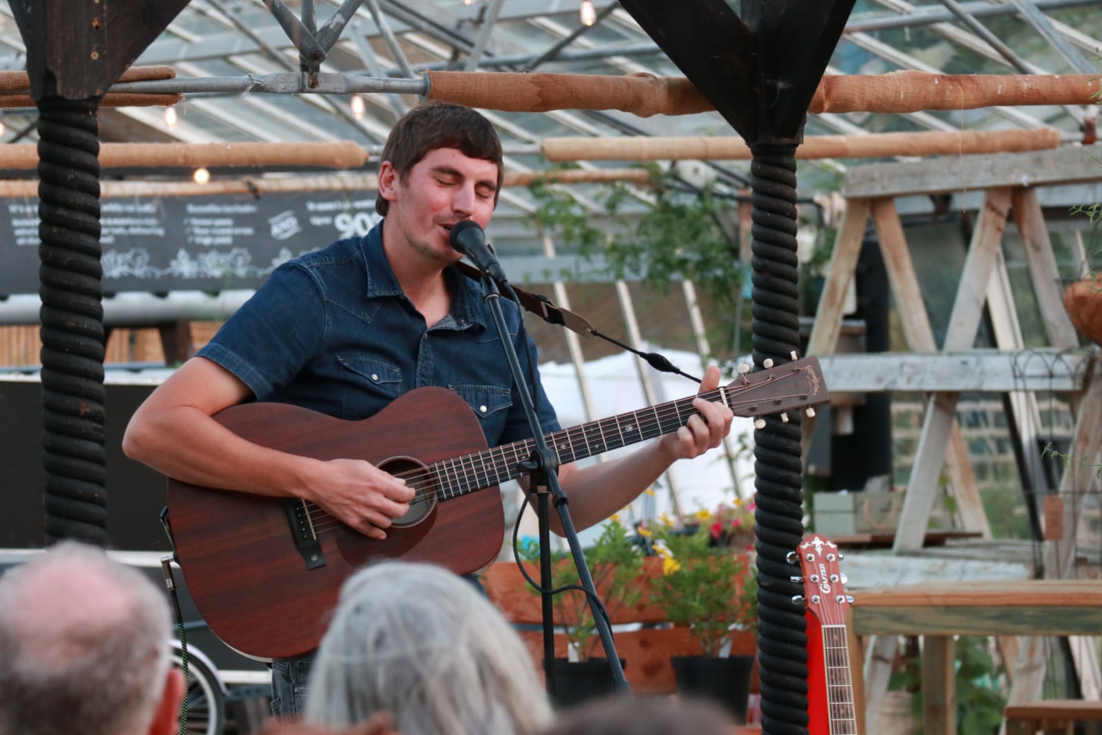Tom Cole singing in the greenhouse